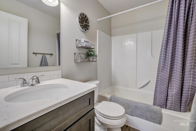 full bathroom with shower / tub combo with curtain, vanity, and toilet