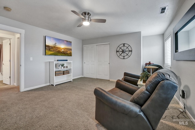 carpeted living room featuring ceiling fan