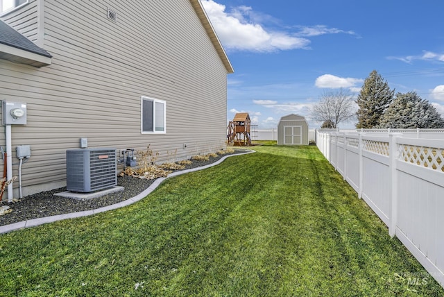 view of yard with a playground, cooling unit, and a storage shed