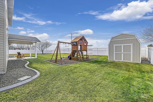 view of yard with a storage unit and a playground