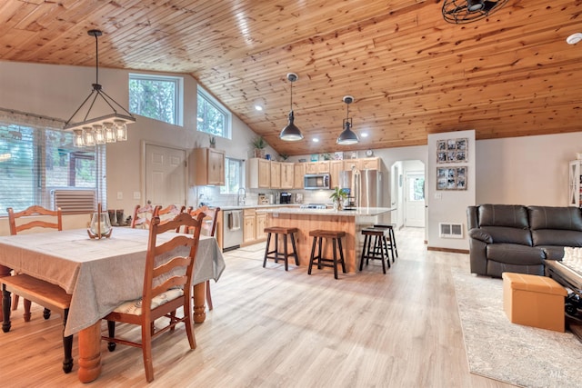 dining area featuring arched walkways, visible vents, wood ceiling, and light wood-style floors