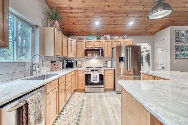 kitchen featuring light brown cabinets, wood ceiling, vaulted ceiling, appliances with stainless steel finishes, and a sink