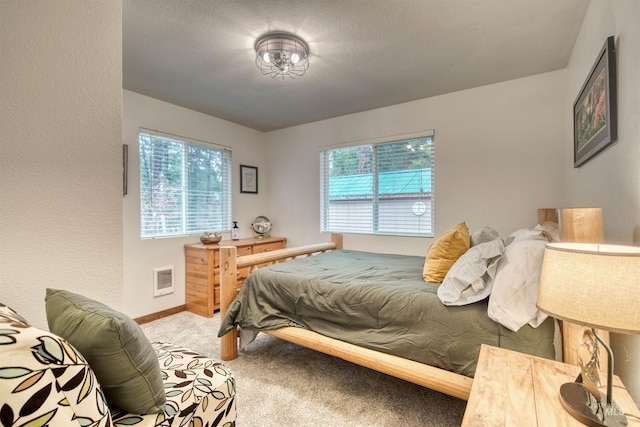 carpeted bedroom with visible vents and baseboards