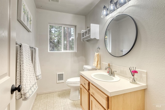 bathroom with vanity, tile patterned floors, toilet, and visible vents