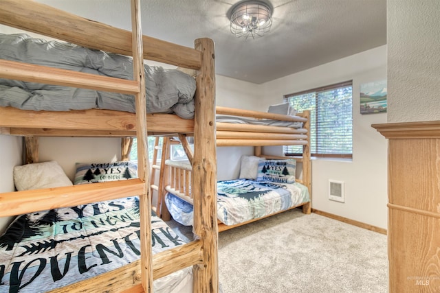 carpeted bedroom featuring visible vents and baseboards