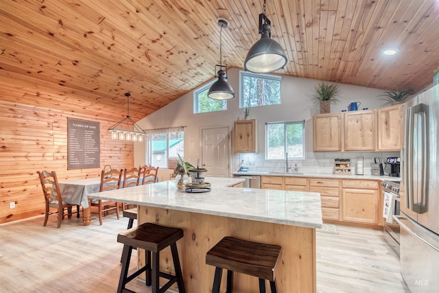 kitchen with light wood-style floors, light brown cabinets, stainless steel appliances, and a sink