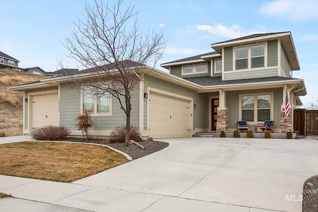 prairie-style house featuring a porch, a garage, and a front lawn