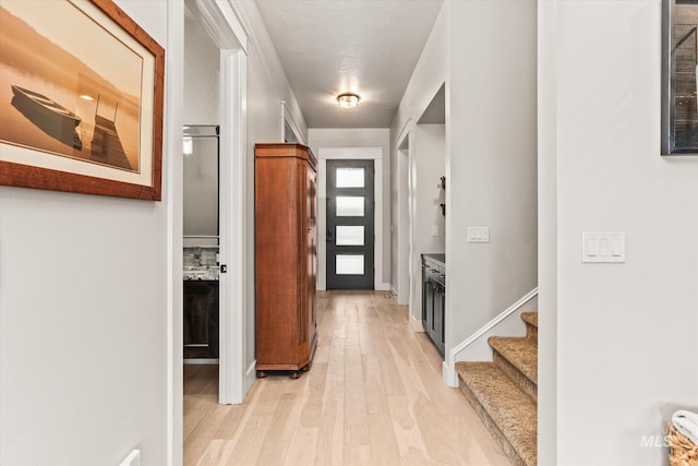 corridor with light hardwood / wood-style flooring