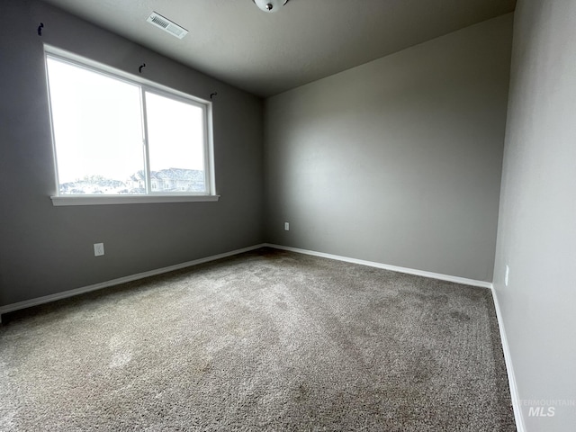 carpeted spare room with baseboards
