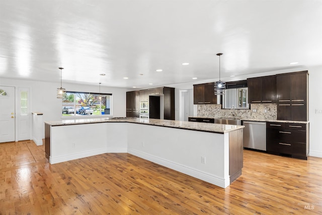 kitchen with stainless steel appliances, light wood-style flooring, plenty of natural light, and recessed lighting