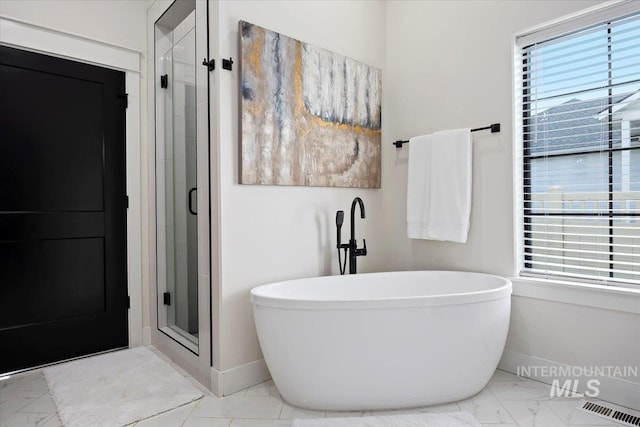 full bath featuring baseboards, a soaking tub, a shower stall, visible vents, and marble finish floor