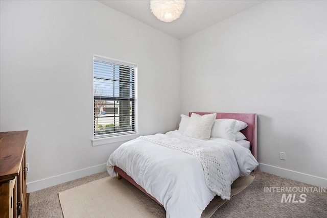 bedroom featuring baseboards and carpet floors