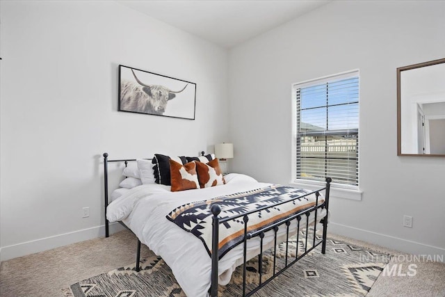 carpeted bedroom featuring baseboards