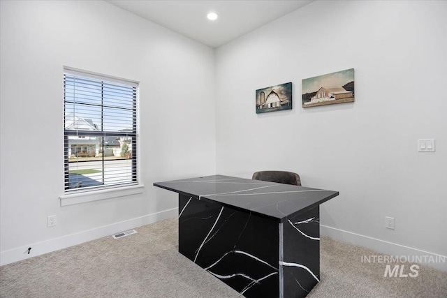 office area with visible vents, baseboards, and carpet