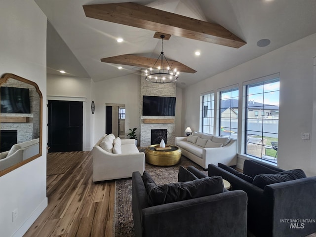 living area featuring a notable chandelier, a stone fireplace, beamed ceiling, high vaulted ceiling, and wood finished floors