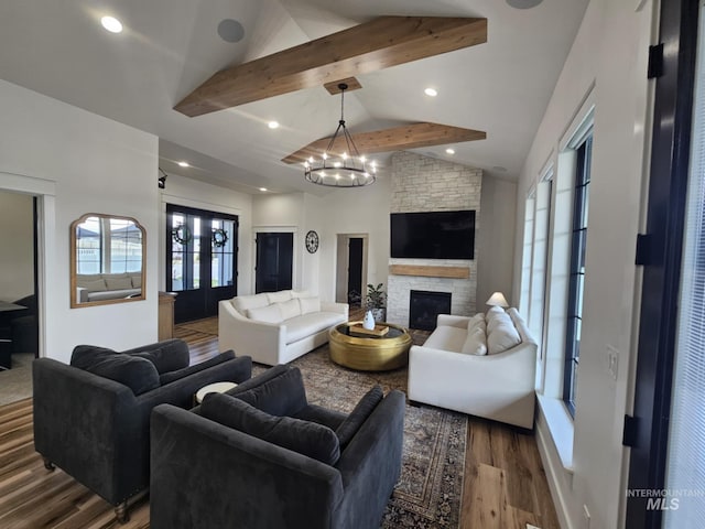 living area featuring a fireplace, lofted ceiling with beams, recessed lighting, a chandelier, and wood finished floors