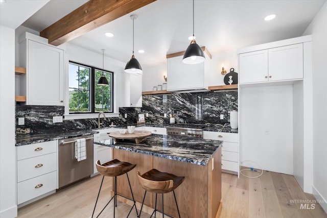 kitchen with dishwasher, white cabinetry, a center island, and backsplash