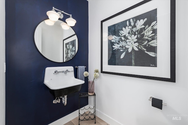 bathroom with sink and hardwood / wood-style flooring