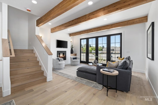 living room with beam ceiling, french doors, and light wood-type flooring