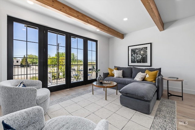 living room featuring beam ceiling, french doors, and light wood-type flooring