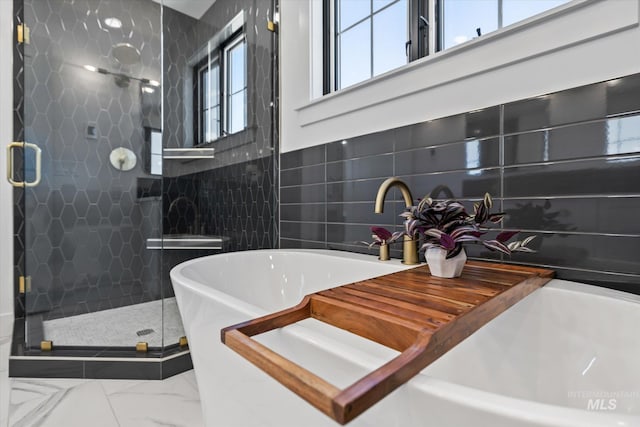 bathroom featuring tile walls, tile floors, and shower with separate bathtub