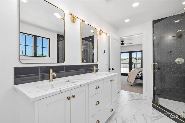 bathroom featuring oversized vanity, ceiling fan, tile floors, walk in shower, and double sink