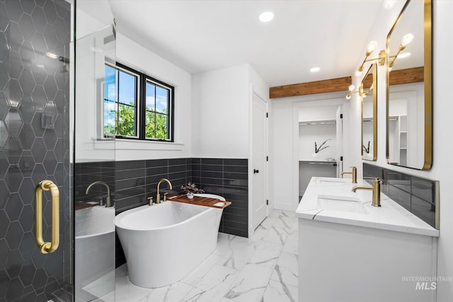 bathroom featuring tile floors, dual vanity, independent shower and bath, and tile walls