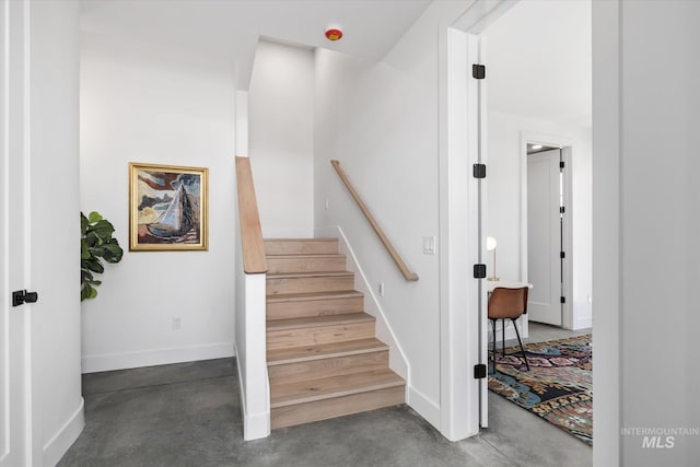 staircase with concrete floors