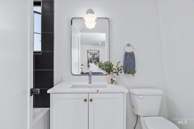 bathroom with toilet and vanity