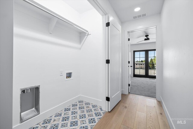 clothes washing area with light carpet, ceiling fan, and washer hookup