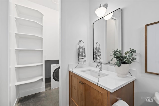 bathroom with washer / dryer, oversized vanity, and concrete flooring