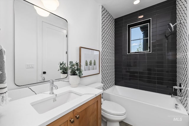 full bathroom with oversized vanity, toilet, and tiled shower / bath combo