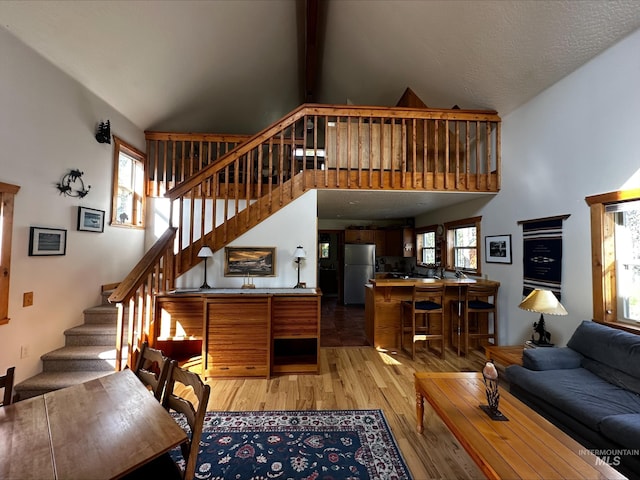 95 Valley Way, Stanley, ID 83278 - living area featuring light wood-style floors, stairway, and high vaulted ceiling