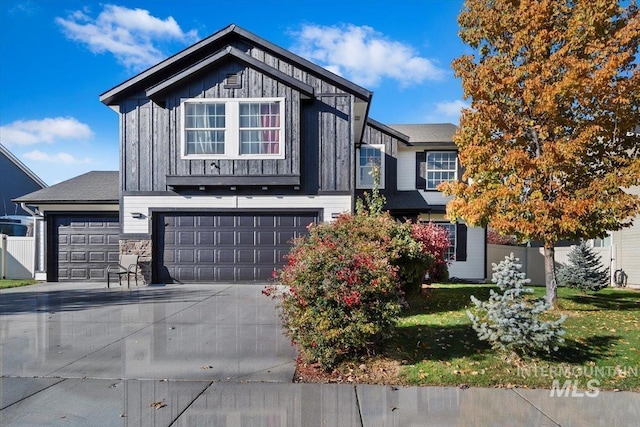 view of front of property with a garage, board and batten siding, driveway, and a front lawn