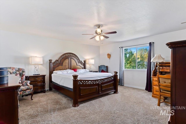 carpeted bedroom featuring ceiling fan, visible vents, and baseboards