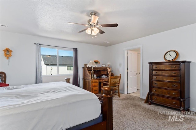 bedroom with light carpet, a ceiling fan, and visible vents