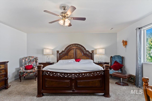 carpeted bedroom with baseboards and ceiling fan