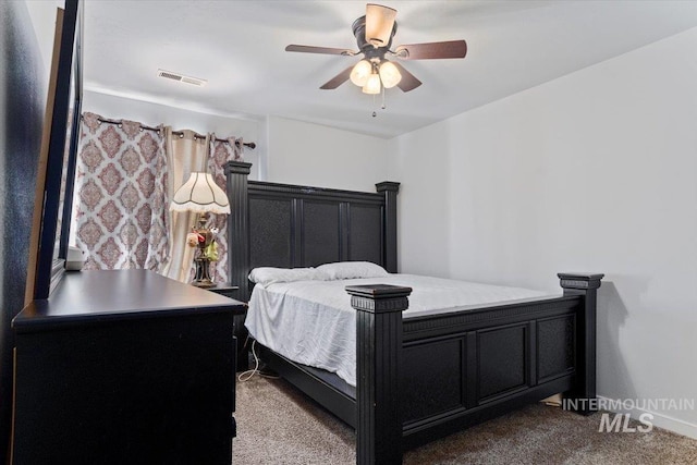 bedroom featuring ceiling fan, dark colored carpet, and visible vents