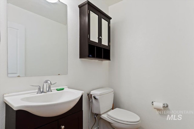 bathroom with vanity and toilet