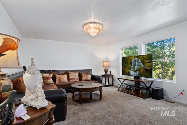 living area with carpet floors and a chandelier