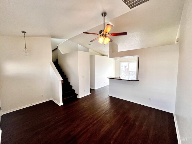 unfurnished living room featuring ceiling fan, vaulted ceiling, and dark hardwood / wood-style flooring