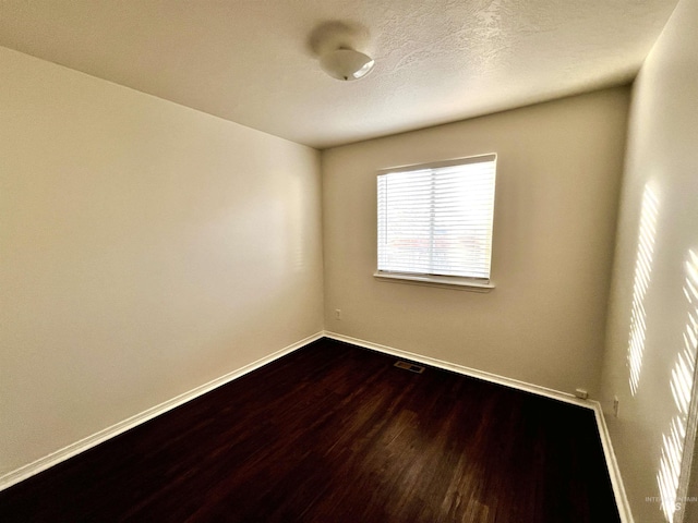 spare room with hardwood / wood-style floors