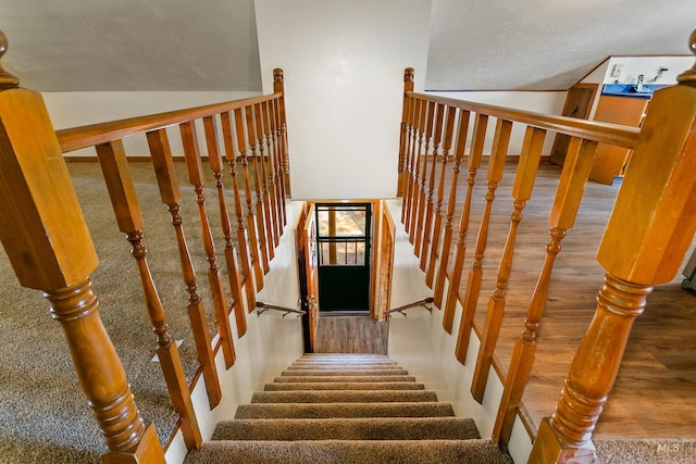 stairs with a textured ceiling