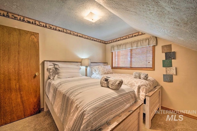 bedroom featuring carpet, a textured ceiling, and vaulted ceiling