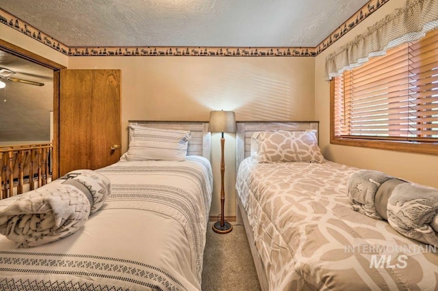 carpeted bedroom with a textured ceiling