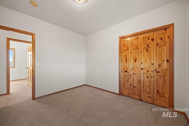 unfurnished bedroom with carpet and baseboards