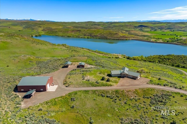 aerial view of property and surrounding area featuring a nearby body of water