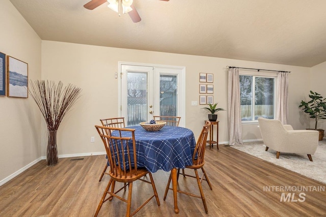 dining area featuring hardwood / wood-style flooring, ceiling fan, and french doors