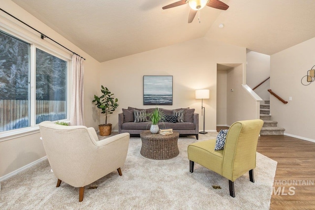 living room featuring lofted ceiling, hardwood / wood-style floors, and ceiling fan