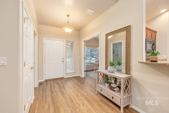 foyer with light wood-type flooring